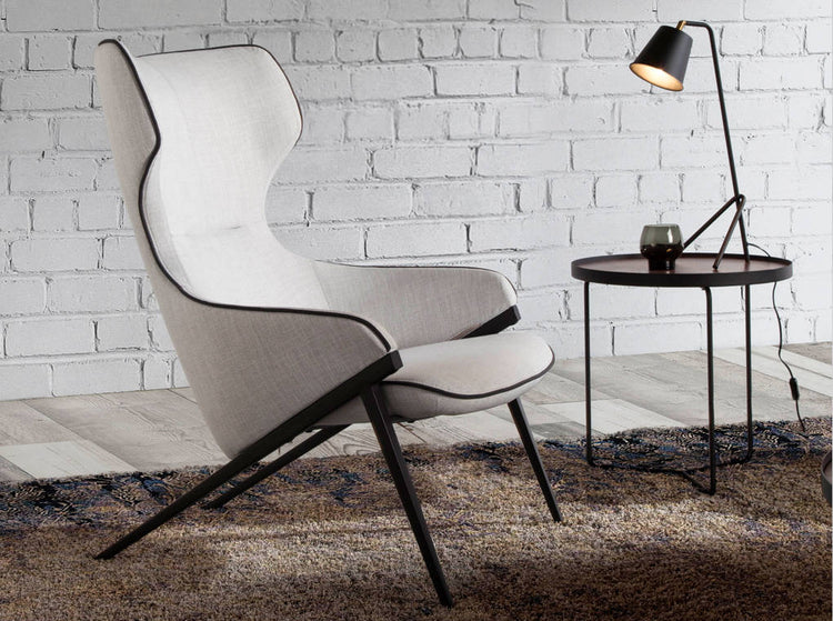 Armchair upholstered in fabric with black steel trim and legs